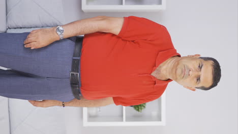 Vertical-video-of-Elderly-man-looking-at-camera-with-negative-expression.